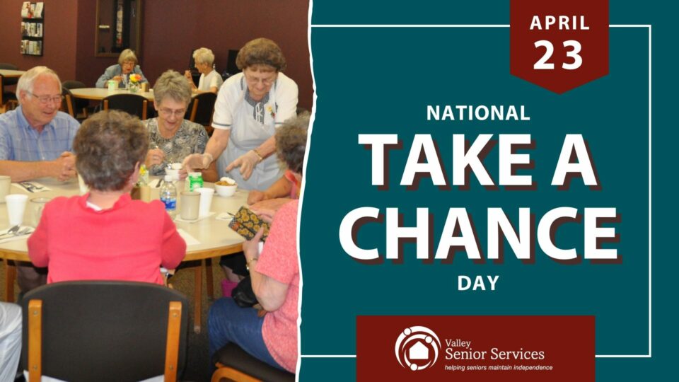 April 23 - National Take A Chance Day - Valley Senior Services - Image of seniors at senior center lunch table being served lunch